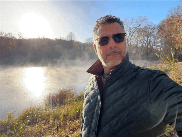 Yasser AlDohaim outdoors by a lake